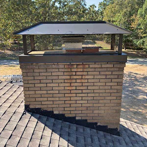 Stainless Steel Outside Mount With Hip & Ridge Lid Black stainless steel outside mount with ladders in background and trees in the background