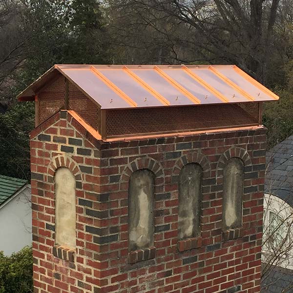 Custom chimney looks like a house with standing seam copper cover